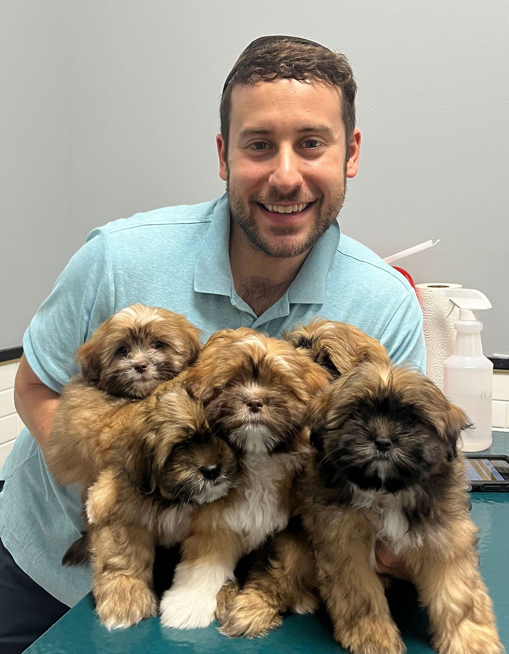 Dr. Maxbetter Vizelberg holding five puppies