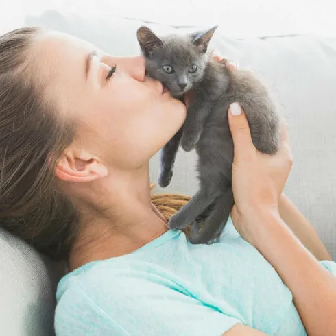 woman playing with cat