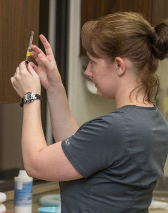 nurse preparing a vaccine at raintree pet medical center