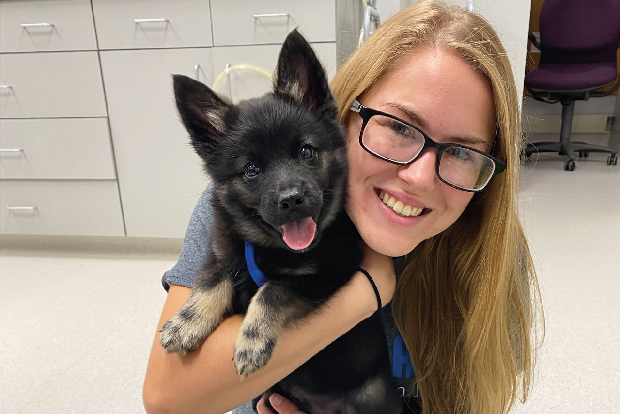 Staff Holding Puppy