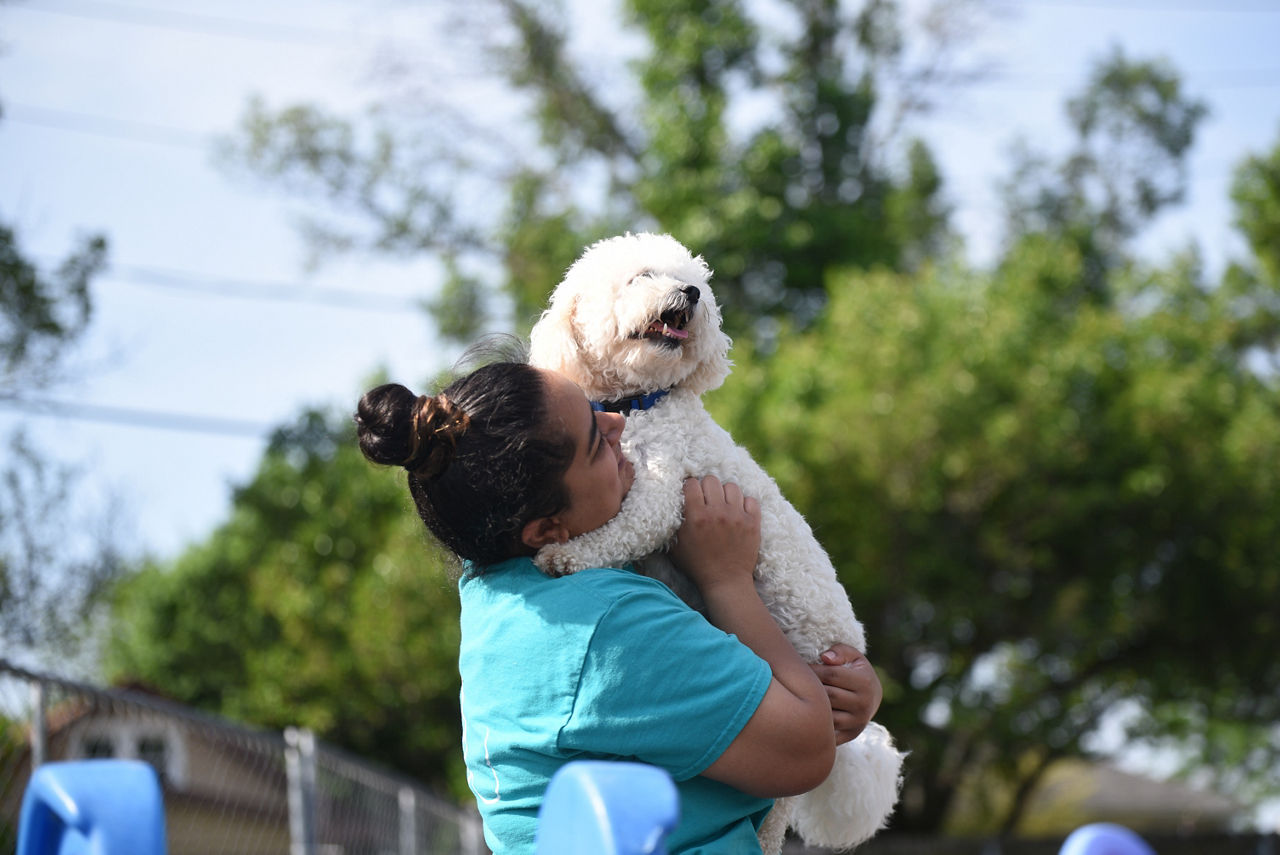 Woman holding puppy.