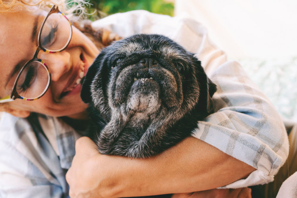 Woman hugging old dog