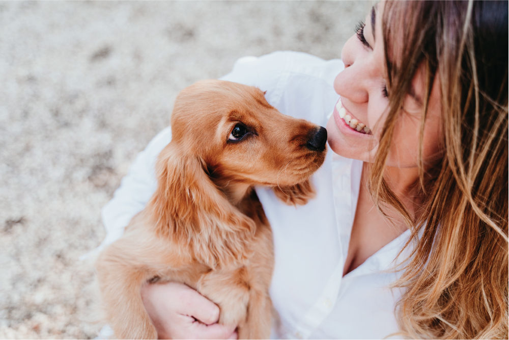 Woman holding puppy.