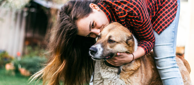 woman loving to her dog